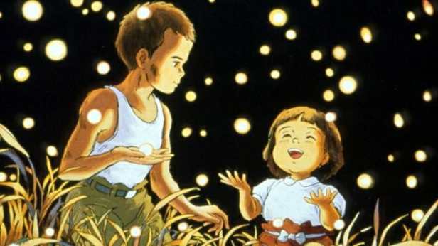 Young boy and girl standing in a field surrounded by fireflies
